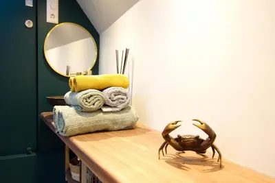 a bathroom with a table with towels and a mirror at Najade Eco Houseboat in Amsterdam