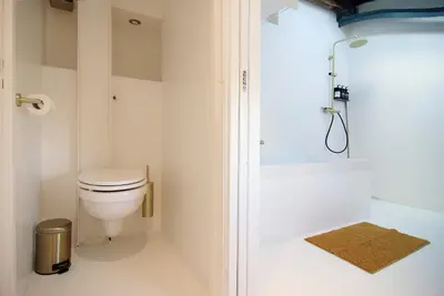 a bathroom with a toilet and a shower at Najade Eco Houseboat in Amsterdam