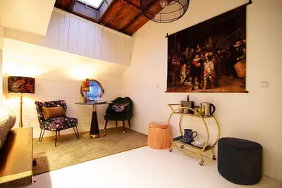 a living room with a painting on the wall at Najade Eco Houseboat in Amsterdam