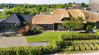 an aerial view of a house with a thatched roof at Het Dijkje Utrecht in Utrecht