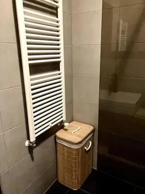 a bathroom with a toilet with a window and a basket at Holiday home Beachy Days near ocean & lake in Noordwijkerhout