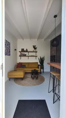 a living room with a couch and a table at Koninginnehuis 35 in Zandvoort