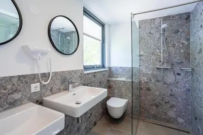a bathroom with a sink toilet and a shower at Duyndomein Noordwijk in Noordwijk