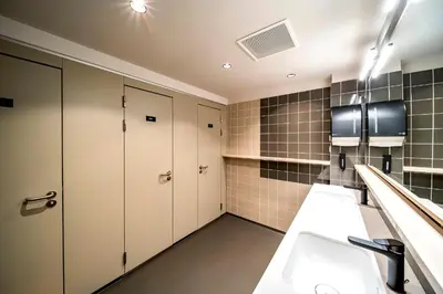a bathroom with white cabinets and a sink at The Bee Hostel in Amsterdam