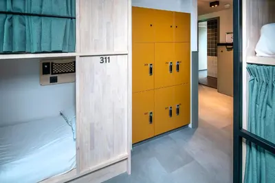 a locker room with yellow lockers in a room at The Bee Hostel in Amsterdam