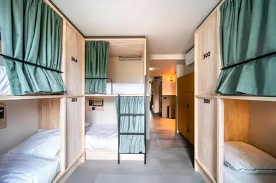 a room with four bunk beds in it at The Bee Hostel in Amsterdam