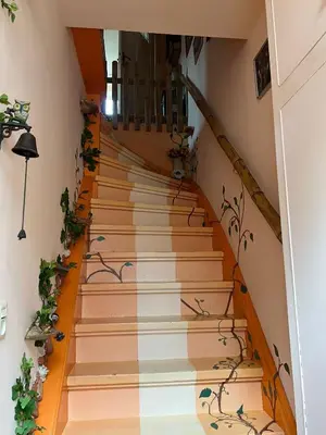 a stairway with flowers painted on it at La Cabaña in Zandvoort