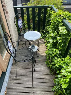 a table and two chairs on a wooden deck at La Cabaña in Zandvoort