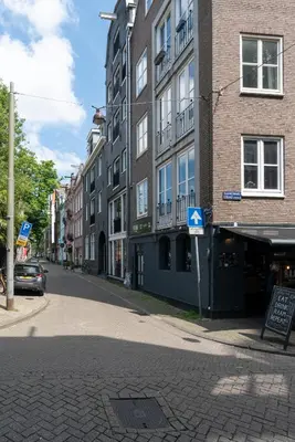 an empty street in a city with buildings at Raam Studio's in Amsterdam