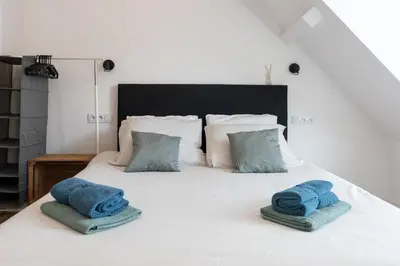 a bedroom with a bed with blue towels on it at Raam Studio's in Amsterdam