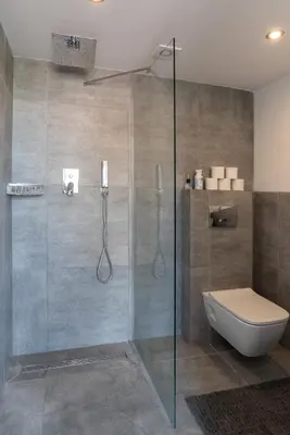 a bathroom with a glass shower with a toilet at Raam Studio's in Amsterdam