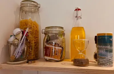 a shelf with jars of food and a clock on it at Studio 41 Bergen NH in Bergen