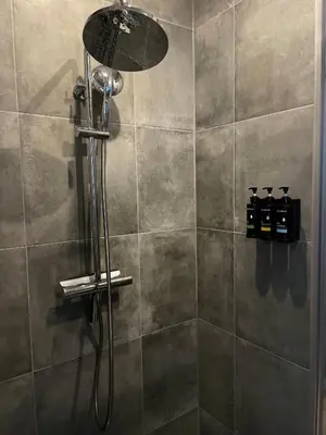 a shower with a shower head in a bathroom at Studio 41 Bergen NH in Bergen