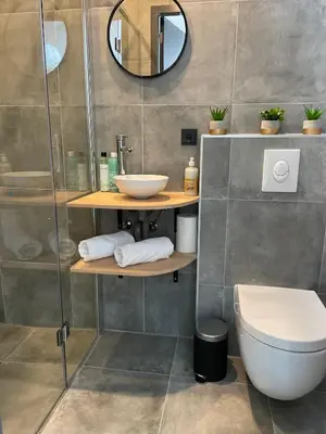 a bathroom with a sink and a toilet and a mirror at Studio 41 Bergen NH in Bergen
