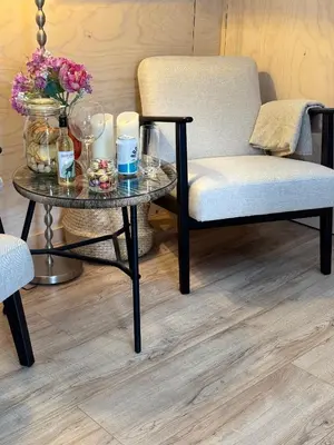 a coffee table with a chair and a table with flowers at Studio 41 Bergen NH in Bergen