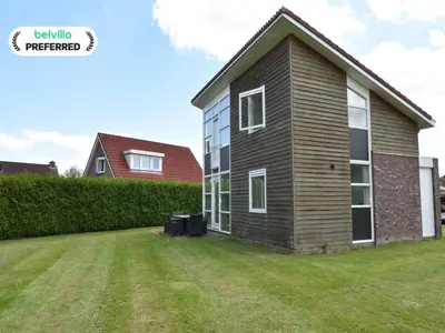 a house with a yard in front of it at Holiday Home in Flevoland with Pool in Zeewolde