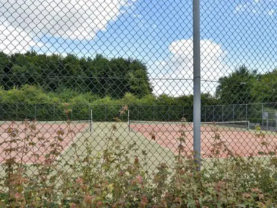 a chain link fence in front of a baseball field at Holiday Home in Flevoland with Pool in Zeewolde