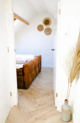 a bedroom with a bed in the middle of a room at Kelp in Egmond aan Zee