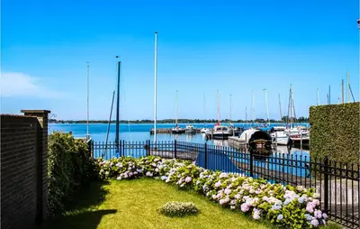 a fence with flowers in front of a marina at Nice Home In Breukeleveen With Wifi in Breukeleveen