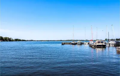 a group of boats docked at a dock in the water at Nice Home In Breukeleveen With Wifi in Breukeleveen
