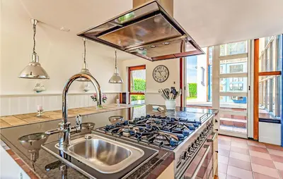 a kitchen with a stove and a sink at Nice Home In Breukeleveen With Wifi in Breukeleveen