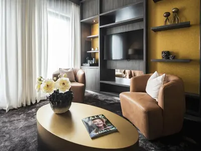 a living room with a table and two chairs and a couch at Van der Valk Hotel Hoorn in Hoorn