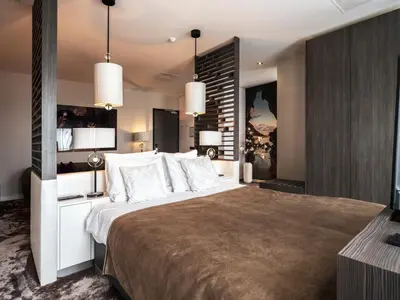 a bedroom with a large bed with white pillows at Van der Valk Hotel Hoorn in Hoorn