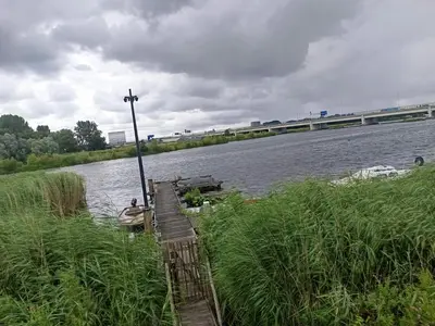 a wooden dock with a cross on the side of a river at All you need, a comfy place in Amsterdam