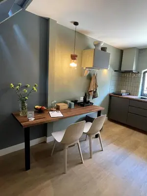 a kitchen with a table and chairs in a room at B&B De Meije in Nieuwkoop