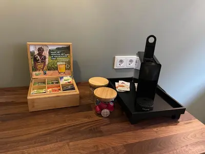 a coffee machine sitting on a counter next to a refrigerator at B&B De Meije in Nieuwkoop