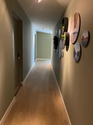 a hallway with plates on the wall and a door at B&B De Meije in Nieuwkoop
