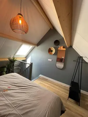 an attic bedroom with a bed and a ceiling at B&B De Meije in Nieuwkoop