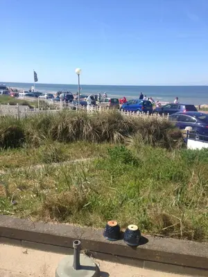 two pairs of shoes sitting on the grass near the beach at Zee en Duin in Zandvoort