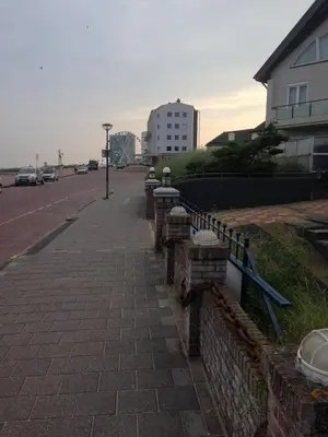 a sidewalk with parking meters on the side of a street at Zee en Duin in Zandvoort