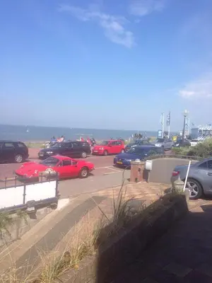 a group of cars parked in a parking lot near the ocean at Zee en Duin in Zandvoort