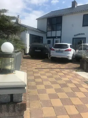 two cars parked in the driveway of a house at Zee en Duin in Zandvoort
