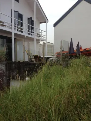a house with boats parked outside of it at Zee en Duin in Zandvoort