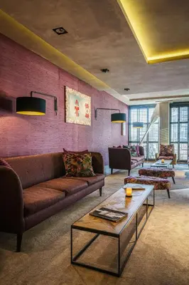 a living room with a couch and a table at DoubleTree by Hilton Amsterdam - NDSM Wharf in Amsterdam