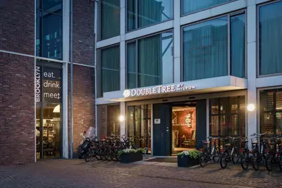 a building with bikes parked outside of it at DoubleTree by Hilton Amsterdam - NDSM Wharf in Amsterdam