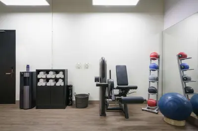 a gym with dumbbells and weights in a room at DoubleTree by Hilton Amsterdam - NDSM Wharf in Amsterdam