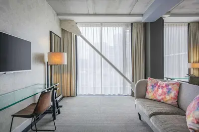a living room with a couch and a television at DoubleTree by Hilton Amsterdam - NDSM Wharf in Amsterdam