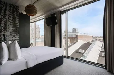 a bedroom with a bed and a large window at DoubleTree by Hilton Amsterdam - NDSM Wharf in Amsterdam