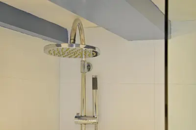 a shower in a bathroom with a shower head at Luxueuze Studio Herengracht in Amsterdam