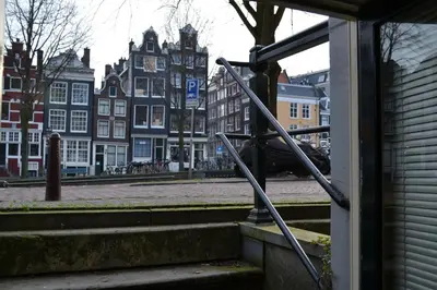 a set of stairs in a city with buildings at Luxueuze Studio Herengracht in Amsterdam