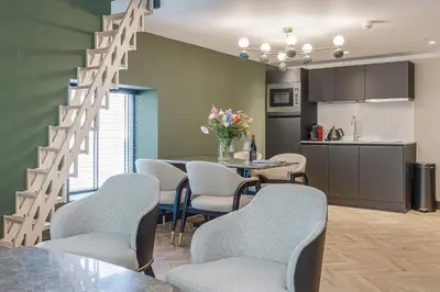 a kitchen and a dining room with a table and chairs at Bens The Walton in Amsterdam