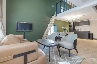 a living room with a couch and chairs and a staircase at Bens The Walton in Amsterdam
