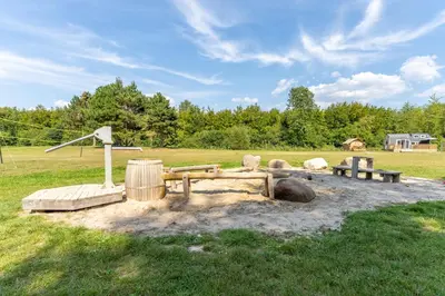 a park with a playground with a picnic table at Green Tiny House with shared pool in Zeewolde