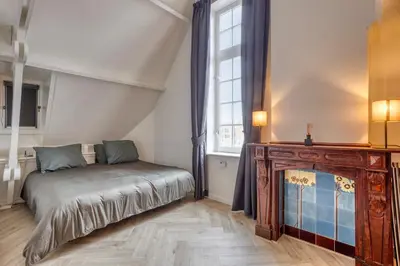 a bedroom with a bed and a large window at Top floor appartment Edam in Edam