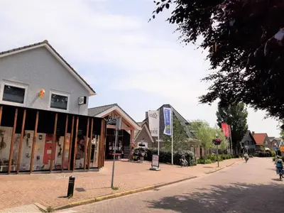 a street in a small town with a building at Stylish holiday home by the sea in Tuitjenhorn