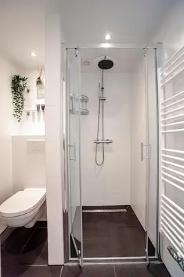 a bathroom with a shower and a toilet at Happy Days Apartment - Luxurious - Free parking on own property in Zandvoort